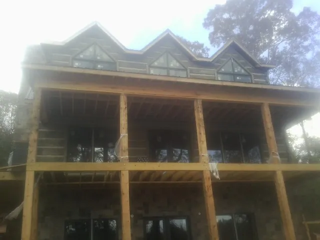 Dormers and porch framing on a large log home under construction in Pleasant Plain