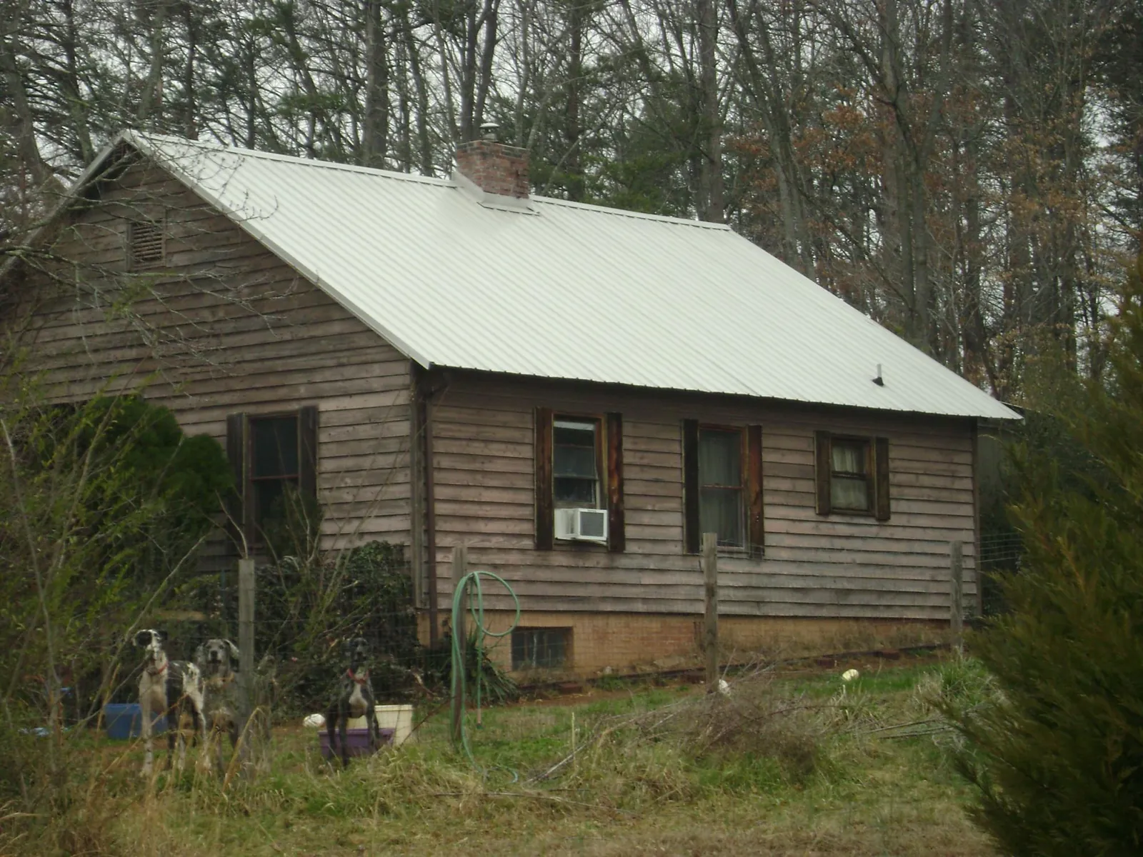White metal roof on an old wood sided farmhouse, from a Metal Roof Installation job in Pleasant Plain